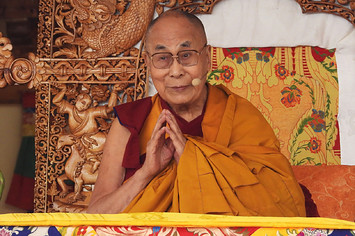 Tibetan spiritual leader Dalai Lama gestures as he leads a teachings gathering in Leh