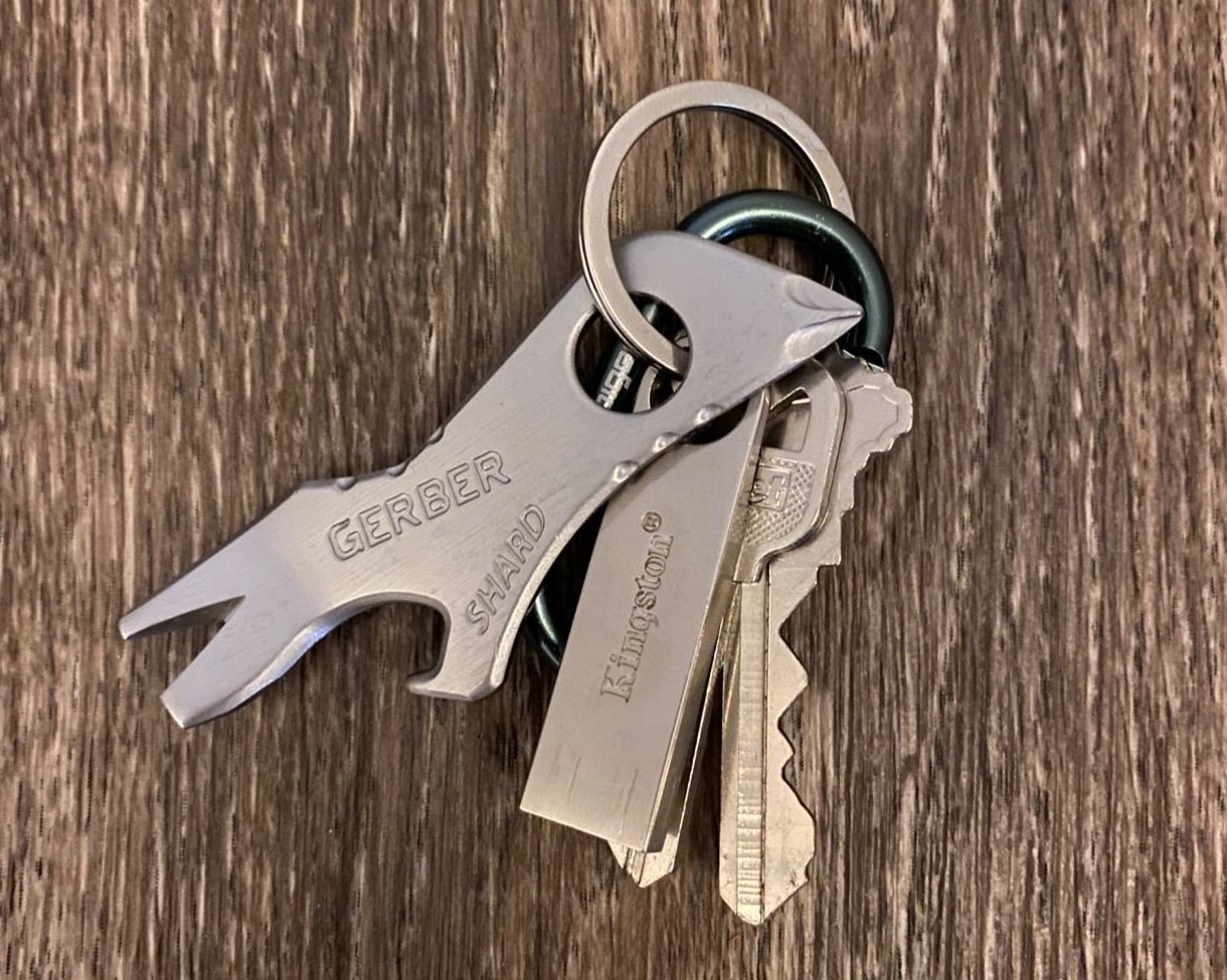 Reviewer&#x27;s photo of keychain tool attached to a set of keys