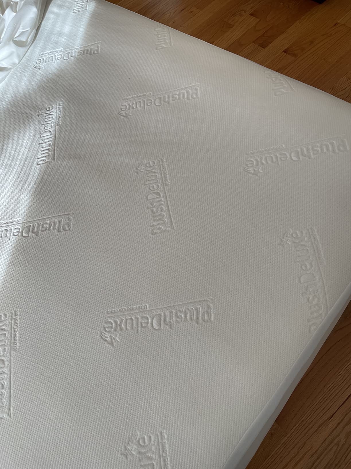 A reviewer&#x27;s photo of the waterproof mattress protector on the bed