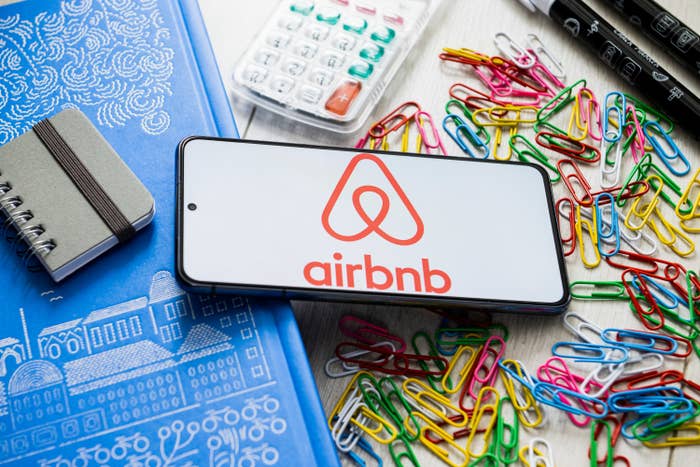 A phone with the Airbnb app open