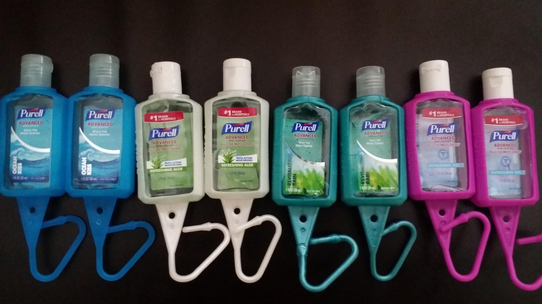 Reviewer&#x27;s photo of travel-sized hand sanitizer bottles in colorful wraps