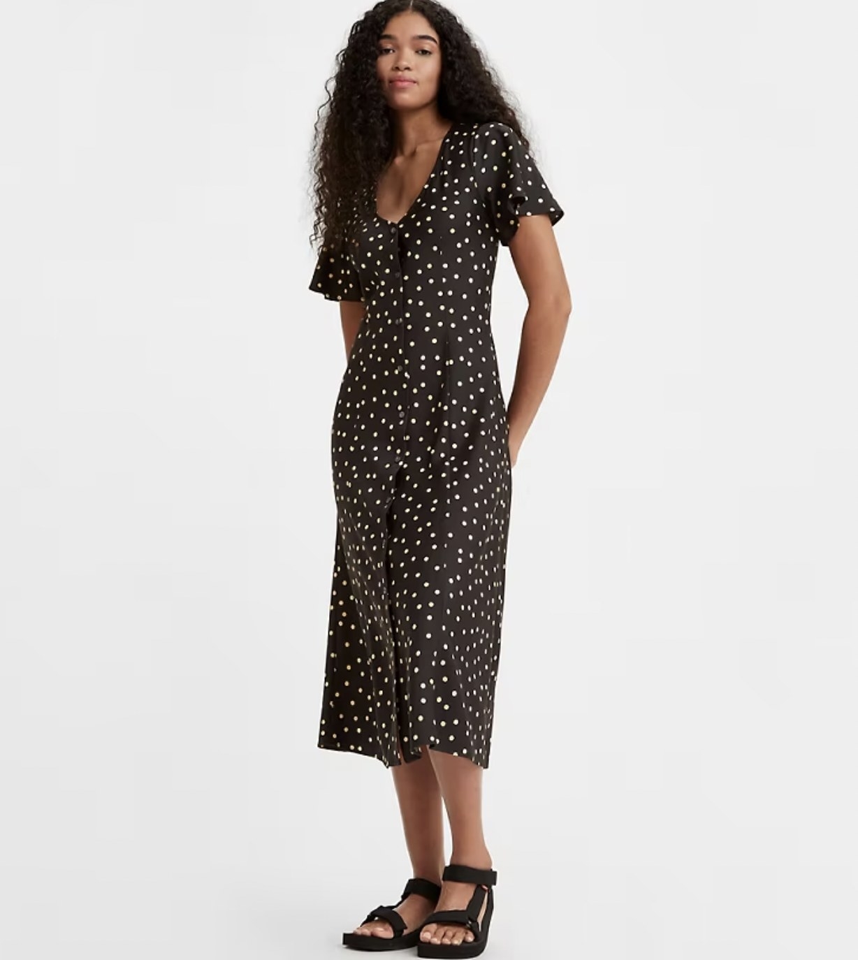 model in the black with daisy patterned dress