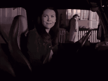 GIF of Lorelai Gilmore driving off in a jeep