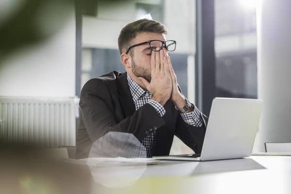 A man looking frustrated at his job