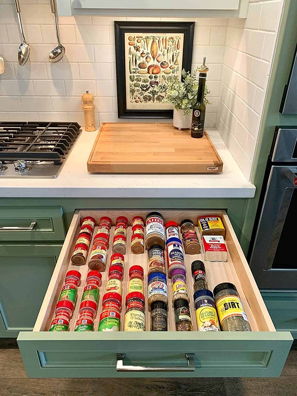 Reviewer&#x27;s photo of a spice drawer organized with the spice drawer organizer