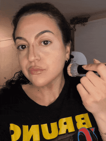 the author applying foundation to her face
