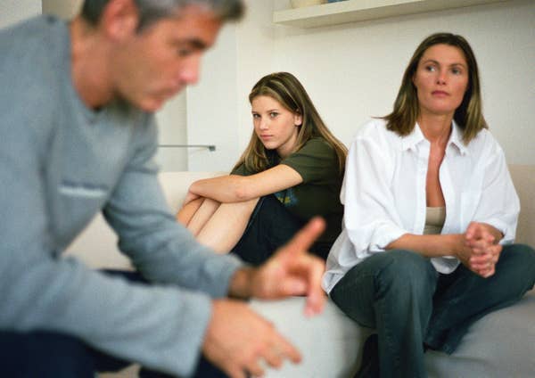 A family sitting down on the couch