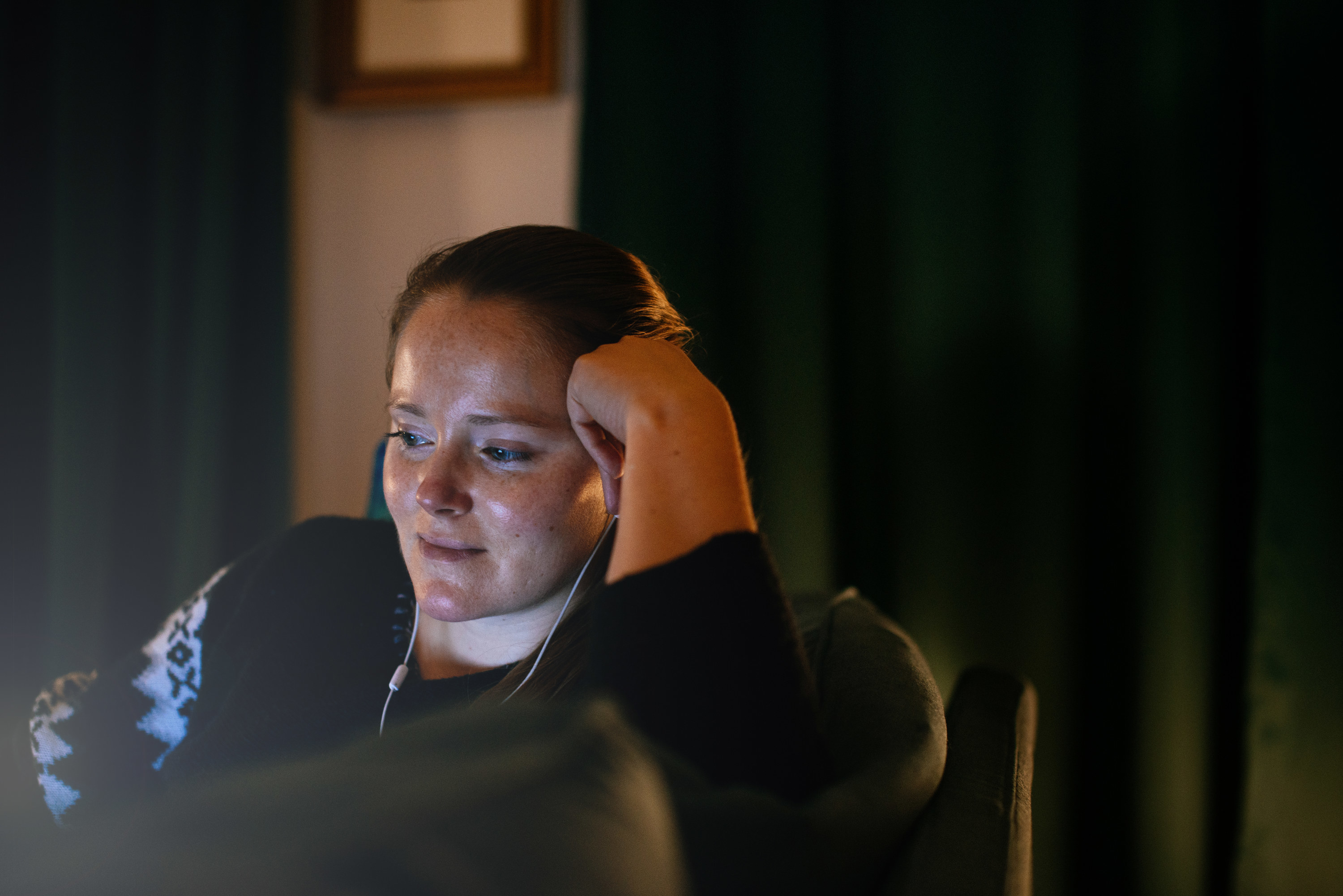 A person watching tv at night