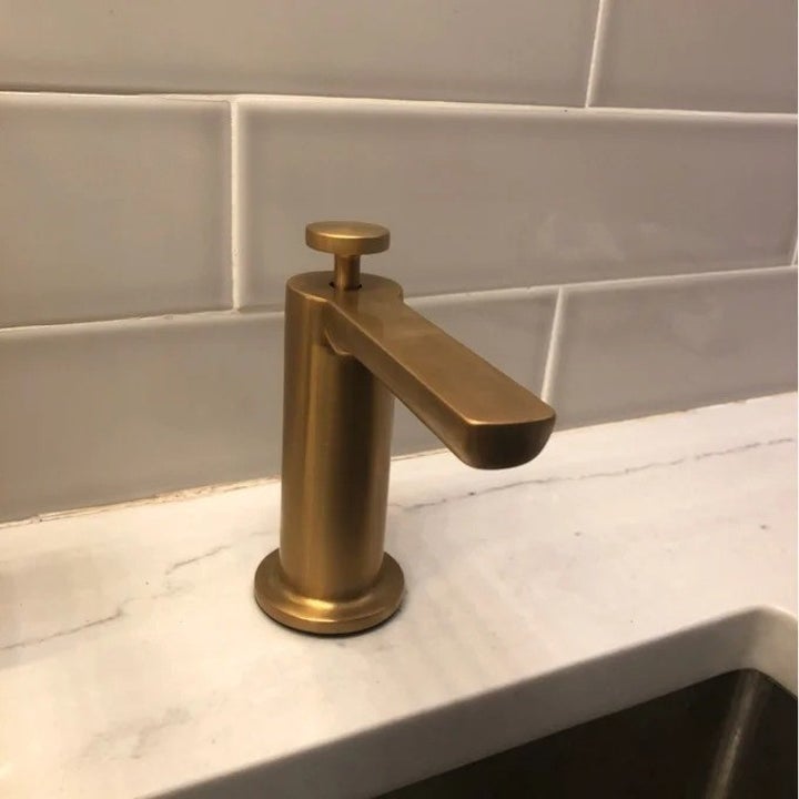 The gold soap dispenser