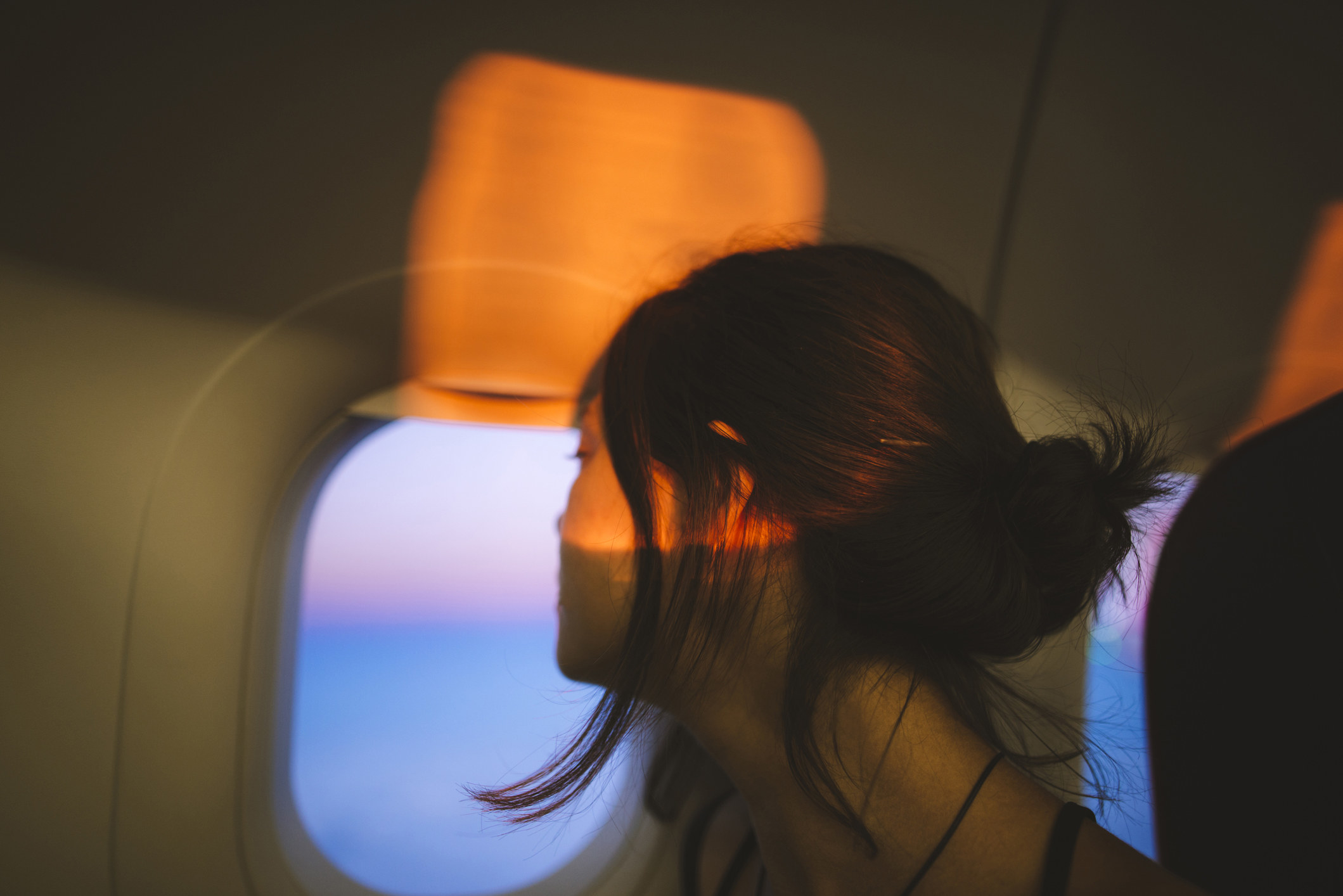 person sitting at the window seat on a plane
