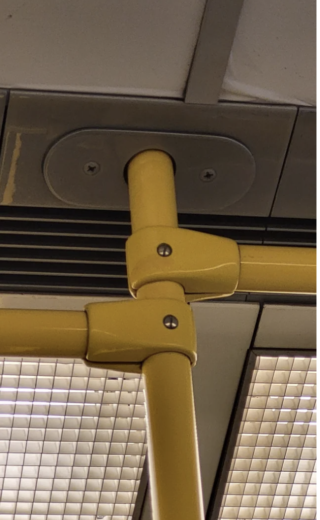 One bus pole has two perpendicular poles holding it in place, but the connectors vaguely look like hands, so it looks like two hands giving a handjob
