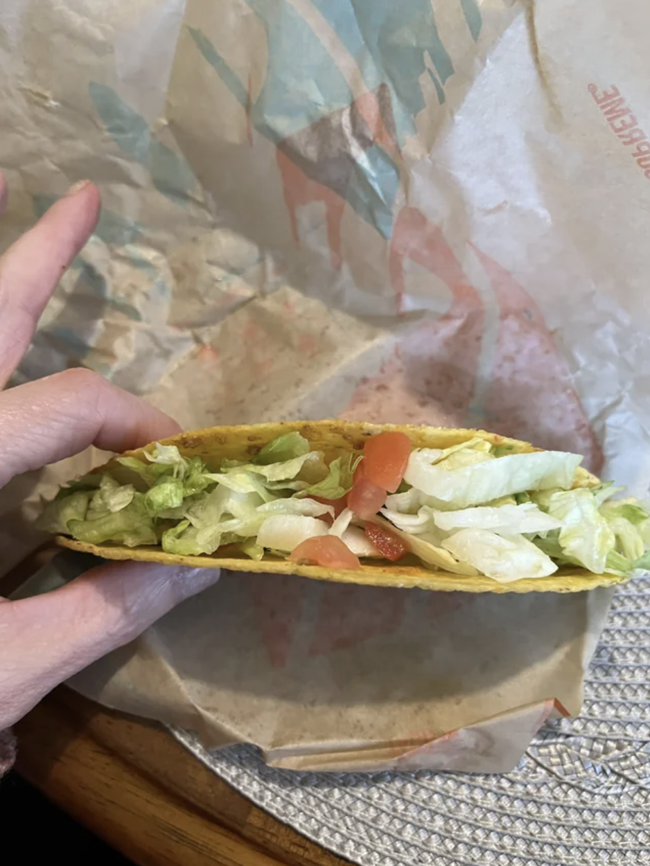 Someone holding up a taco