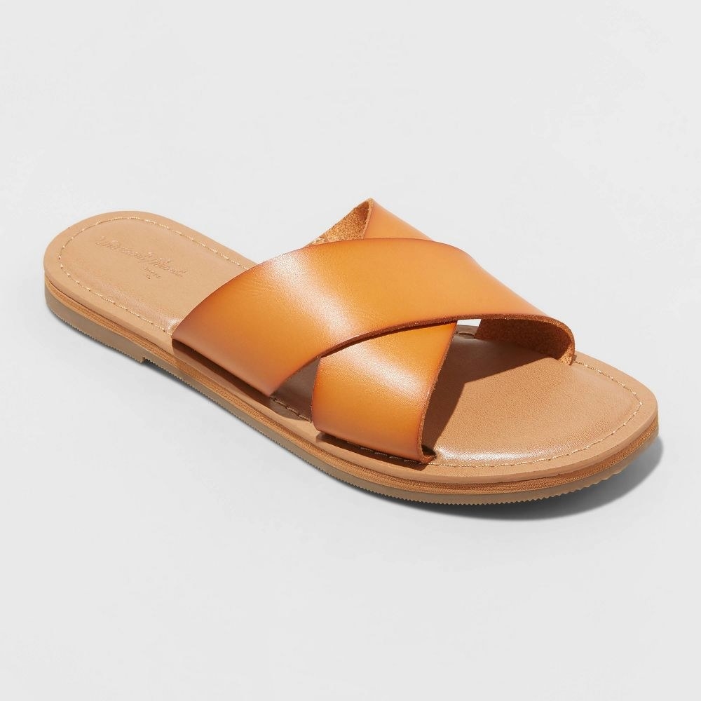 cognac colored slide sandals with a criss cross strap