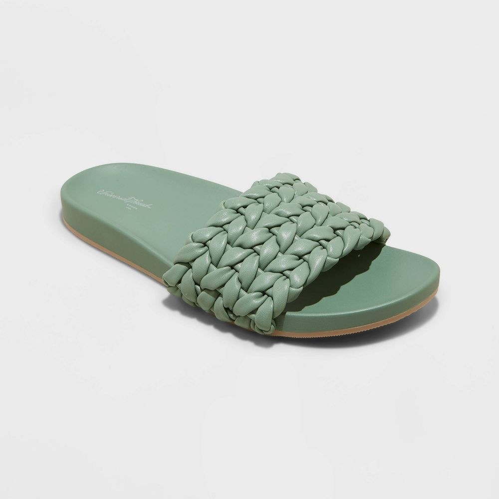 green flat sandals with a braided strap