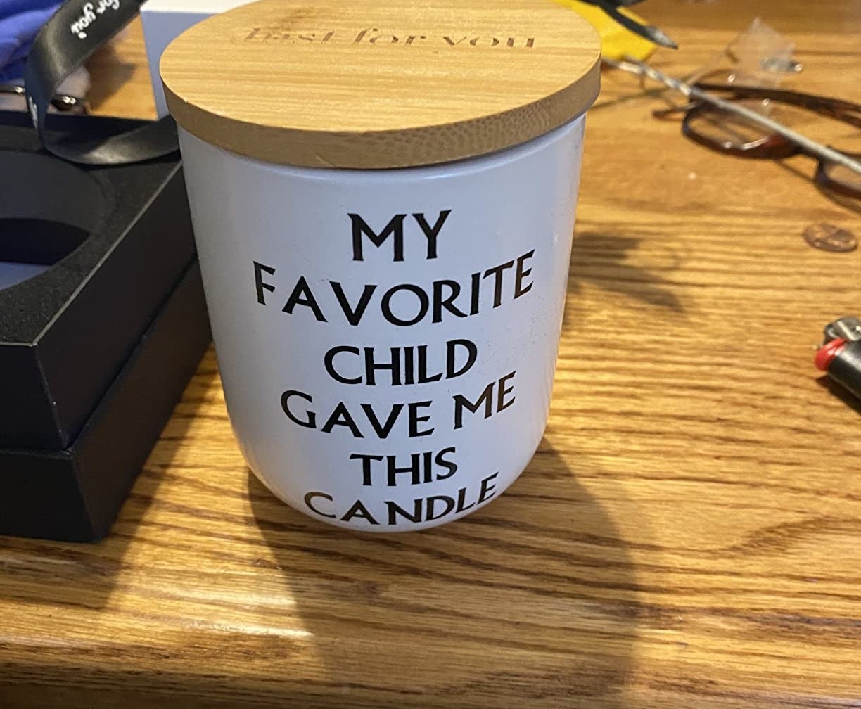a reviewer&#x27;s candle that reads, my favorite child gave me this candle