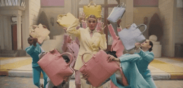Taylor Swift dancing with bags