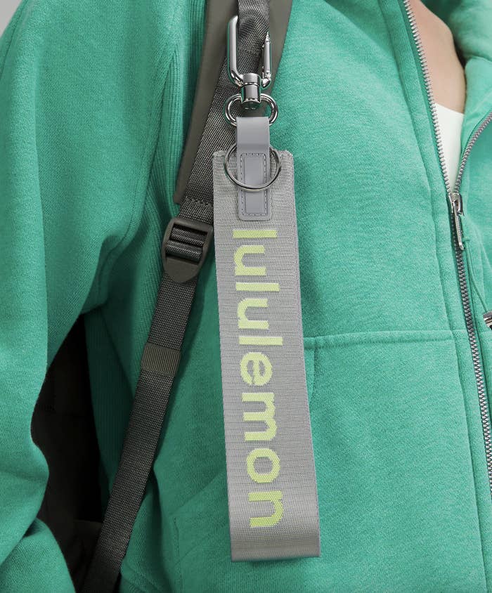 the oversized lululemon keychain clipped to a bag