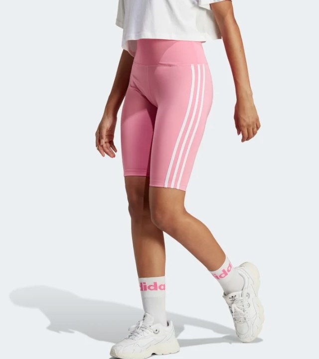A model wearing the adidas Adicolor classics high-waisted short tights in bliss pink