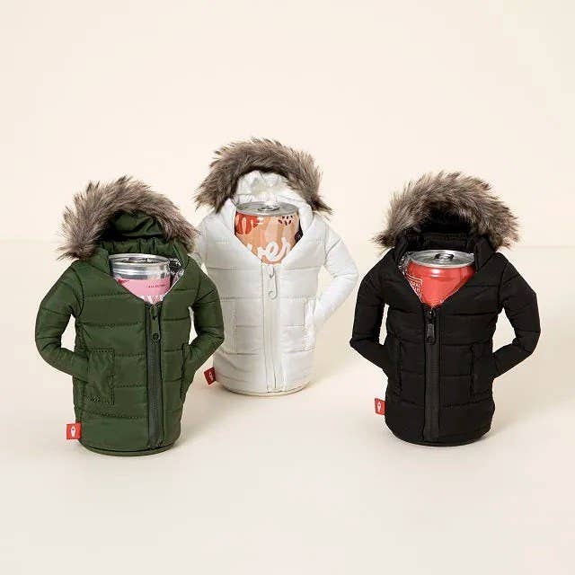 seltzer cans in the olive, white, and black holders, which look like zip up parkas with furry hoods