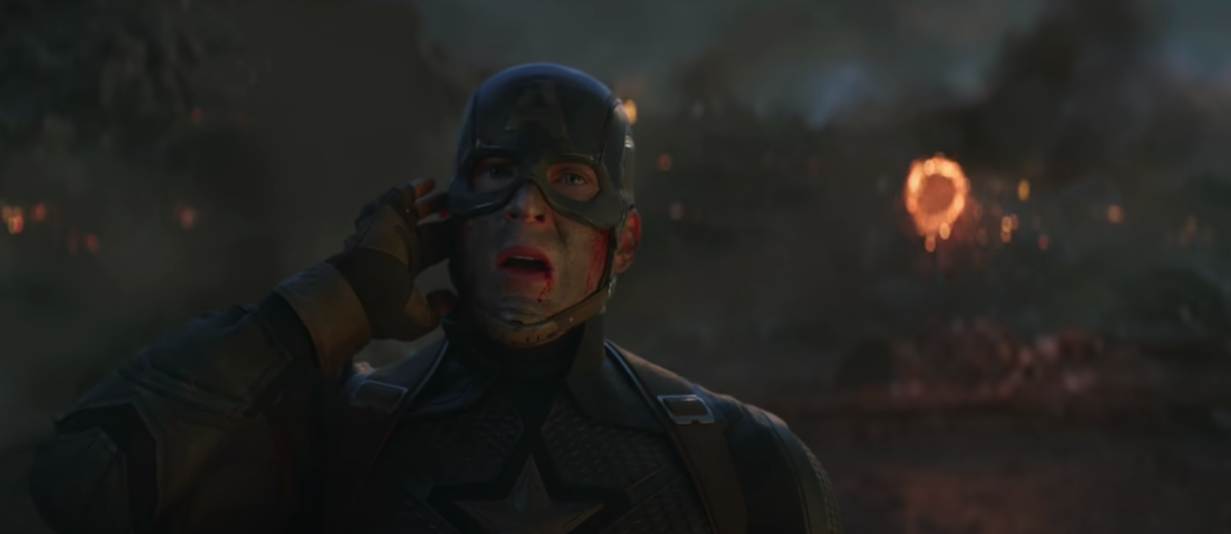 Captain America stands in a battlefield