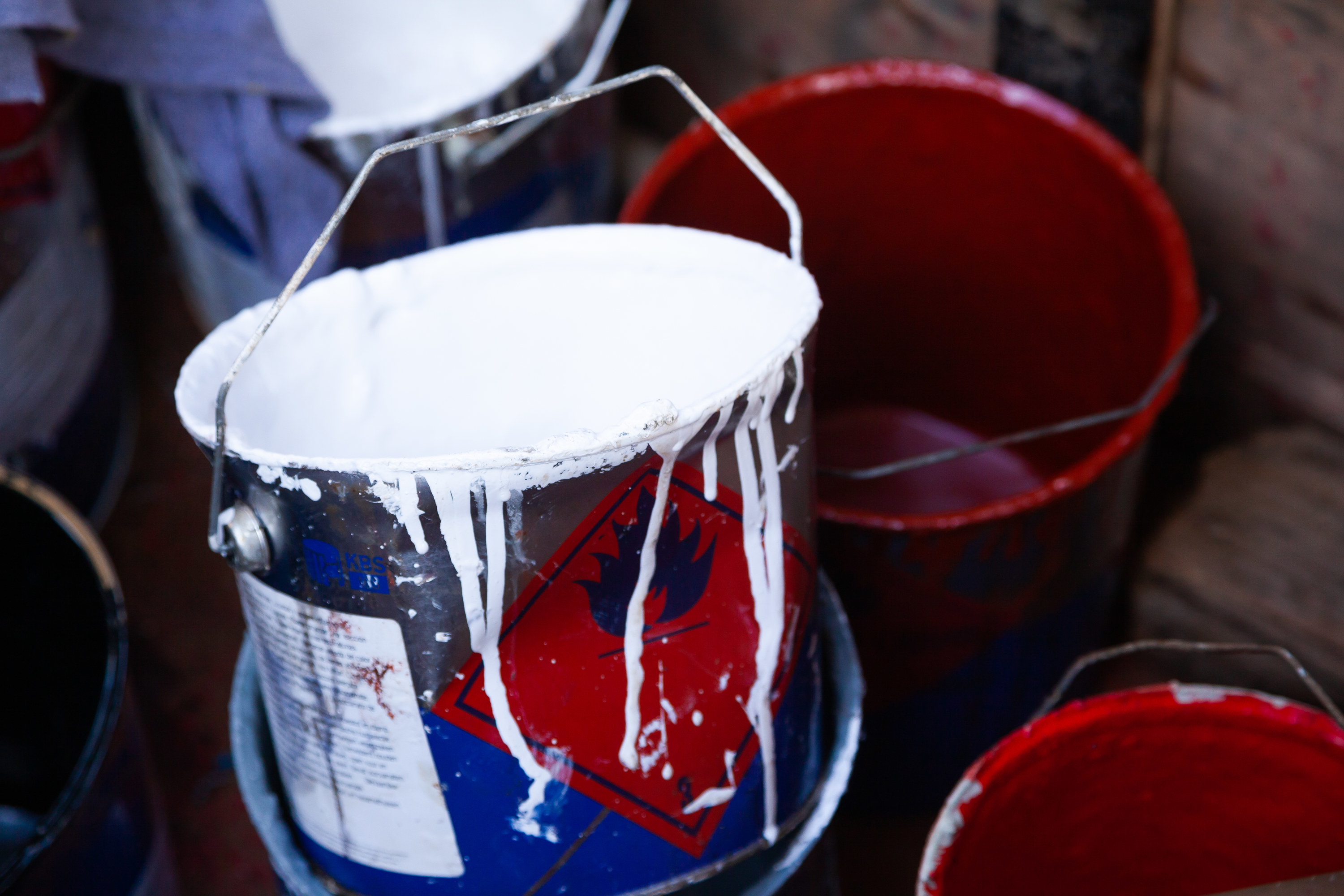 Empty paint bucket with drips on the side