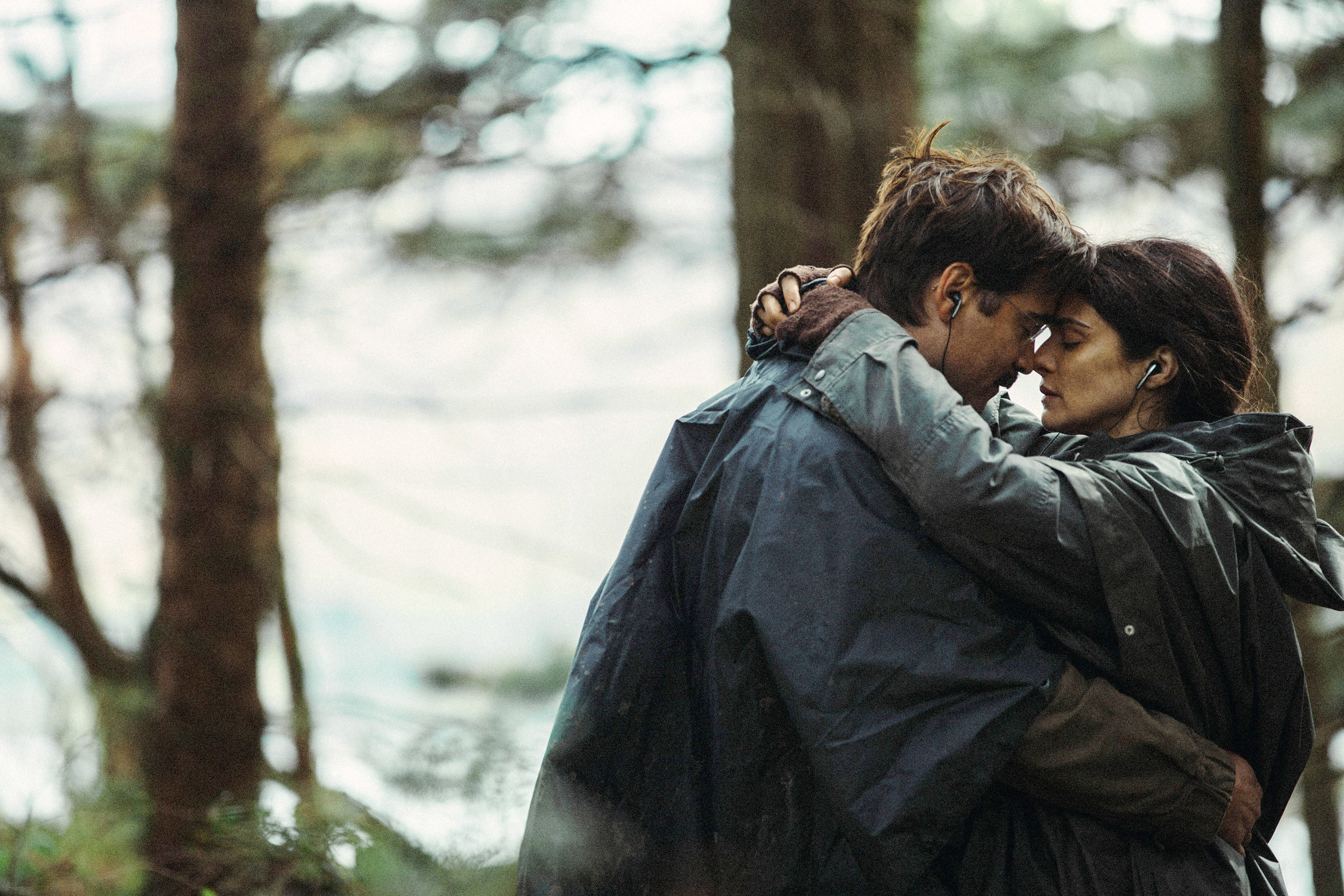 Colin Farrell and Rachel Weisz embrace in the woods