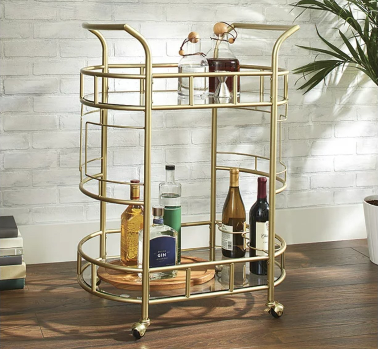 the gold bar cart with several bottles of alcohol