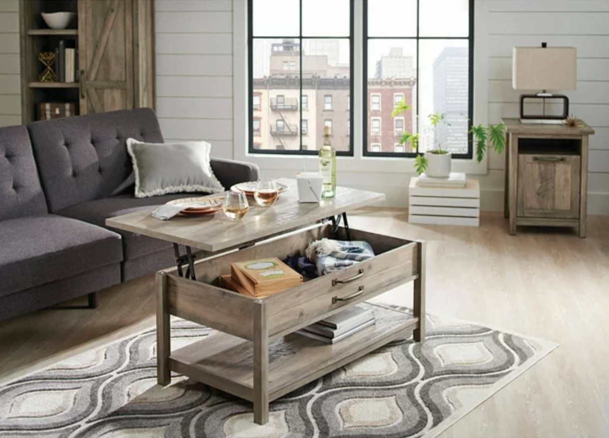 the grey wood coffee table with the lid lifted in a decorated living space