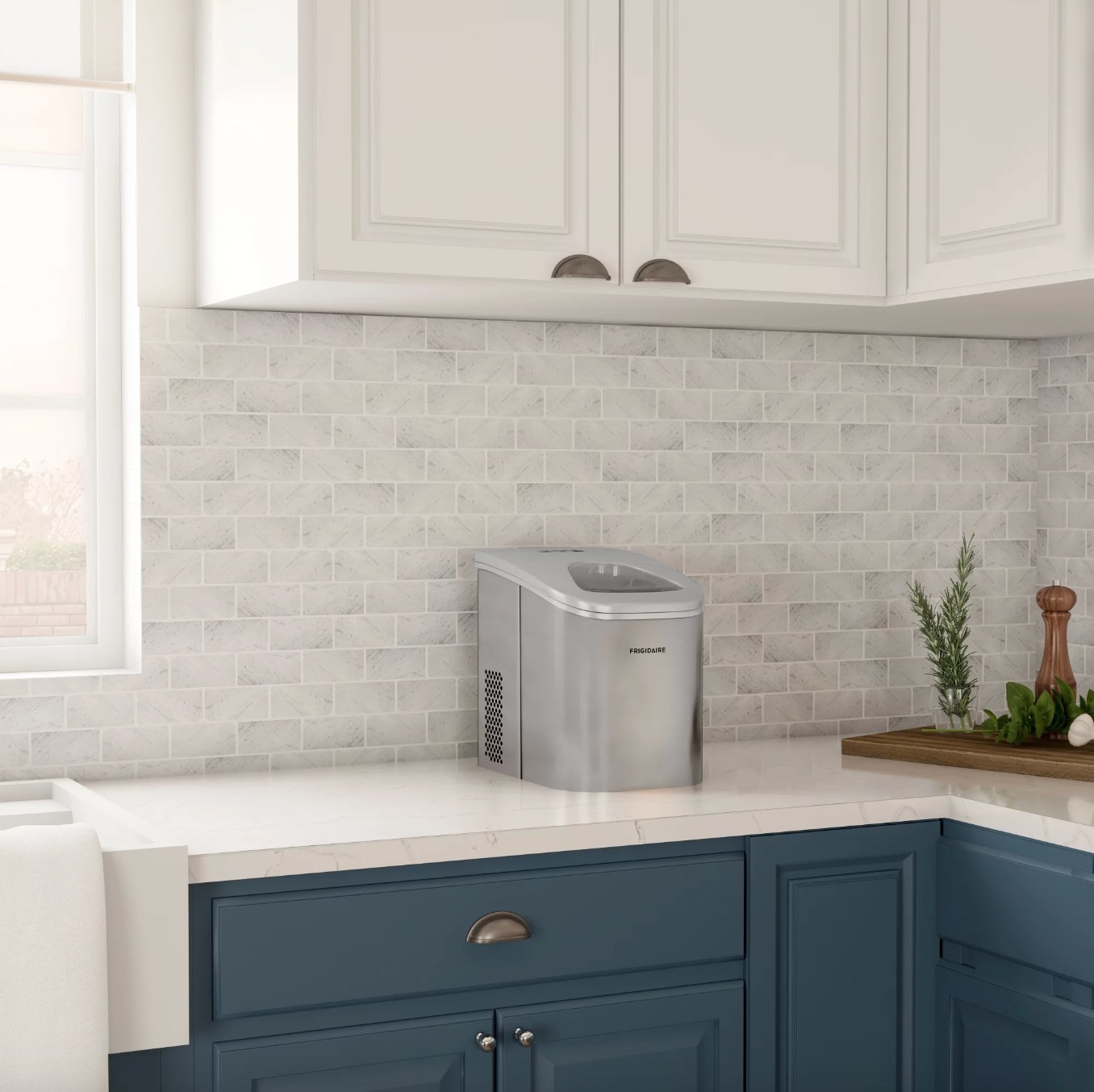 the silver ice maker on the counter in a decorated kitchen space