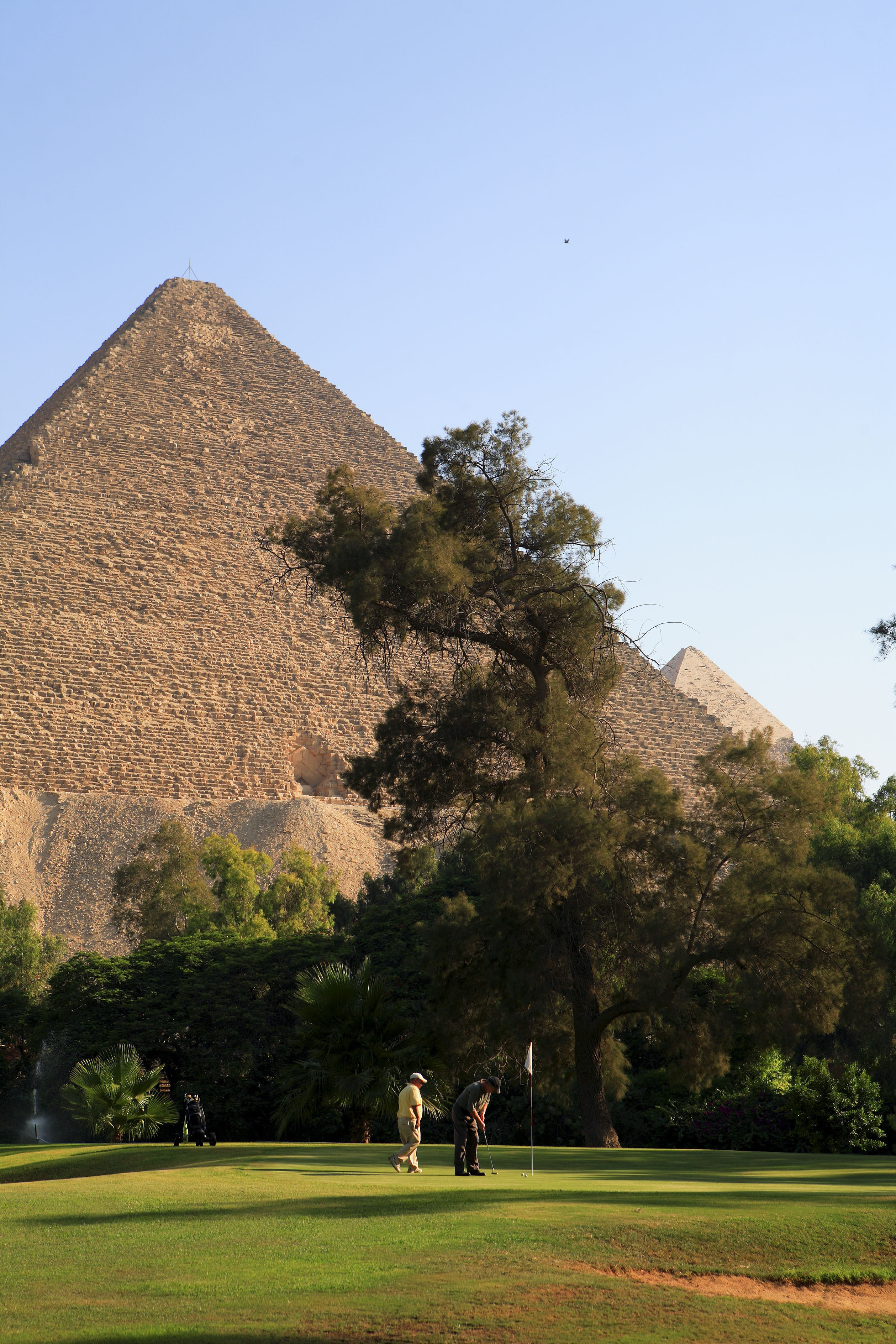 People golfing next to the Pyramid of Giza