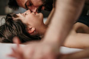a couple kissing and lying down