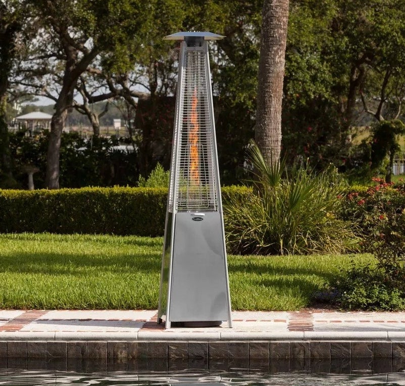stainless steel lit patio heater on side of pool outdoors