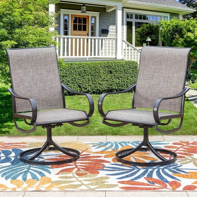 set of gray and black patio swivel rocking chairs on colorful outdoor carpet