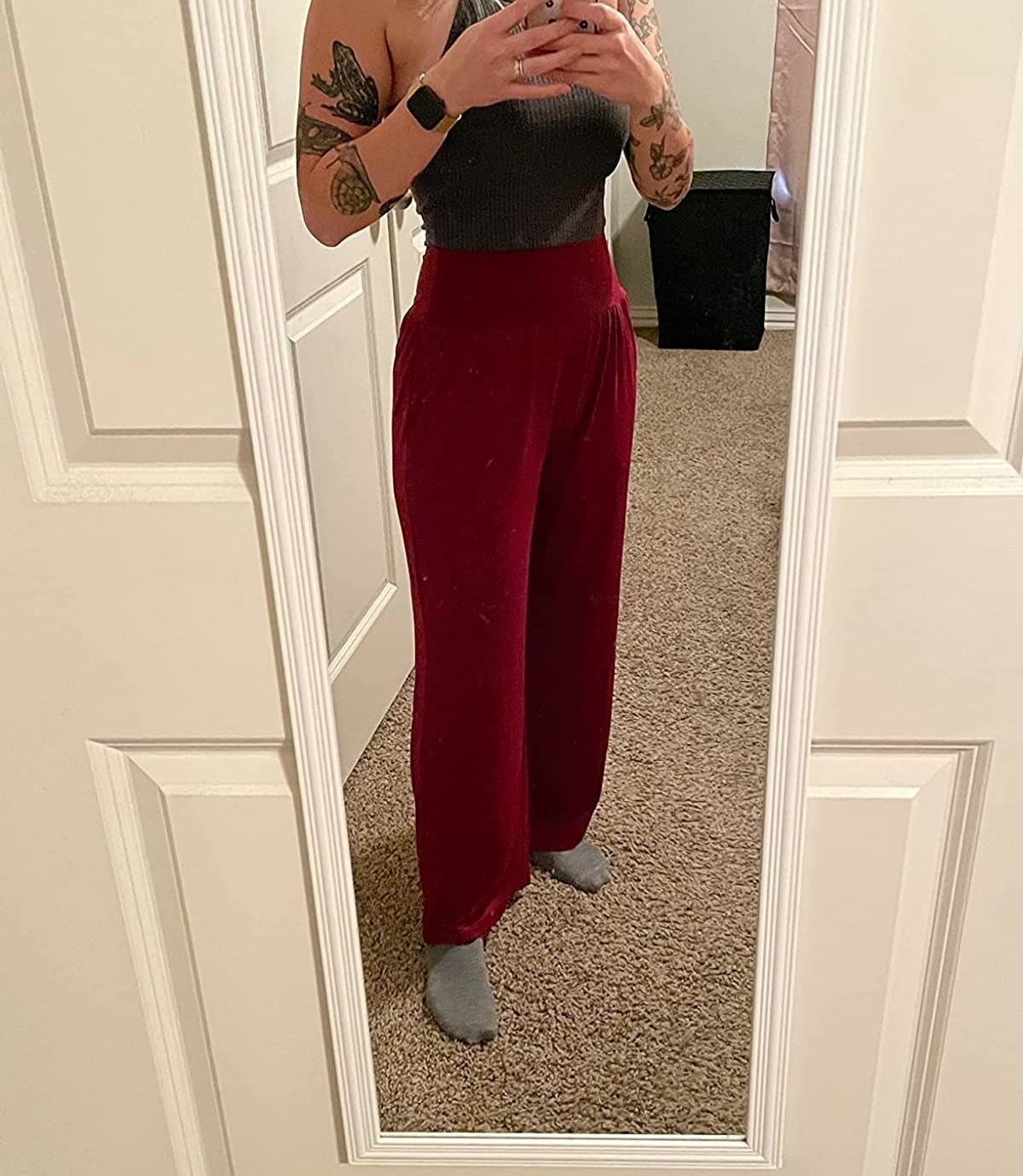 Reviewer wearing red palazzo pants with dark gray halter tank