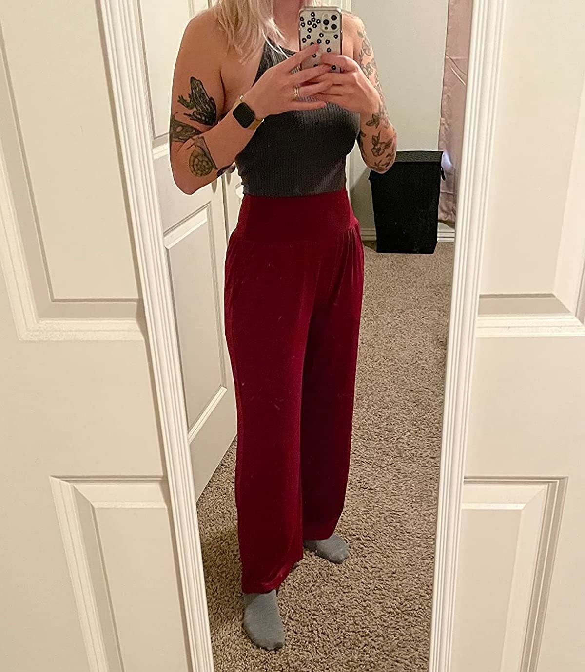 Reviewer wearing red palazzo pants with dark gray halter tank