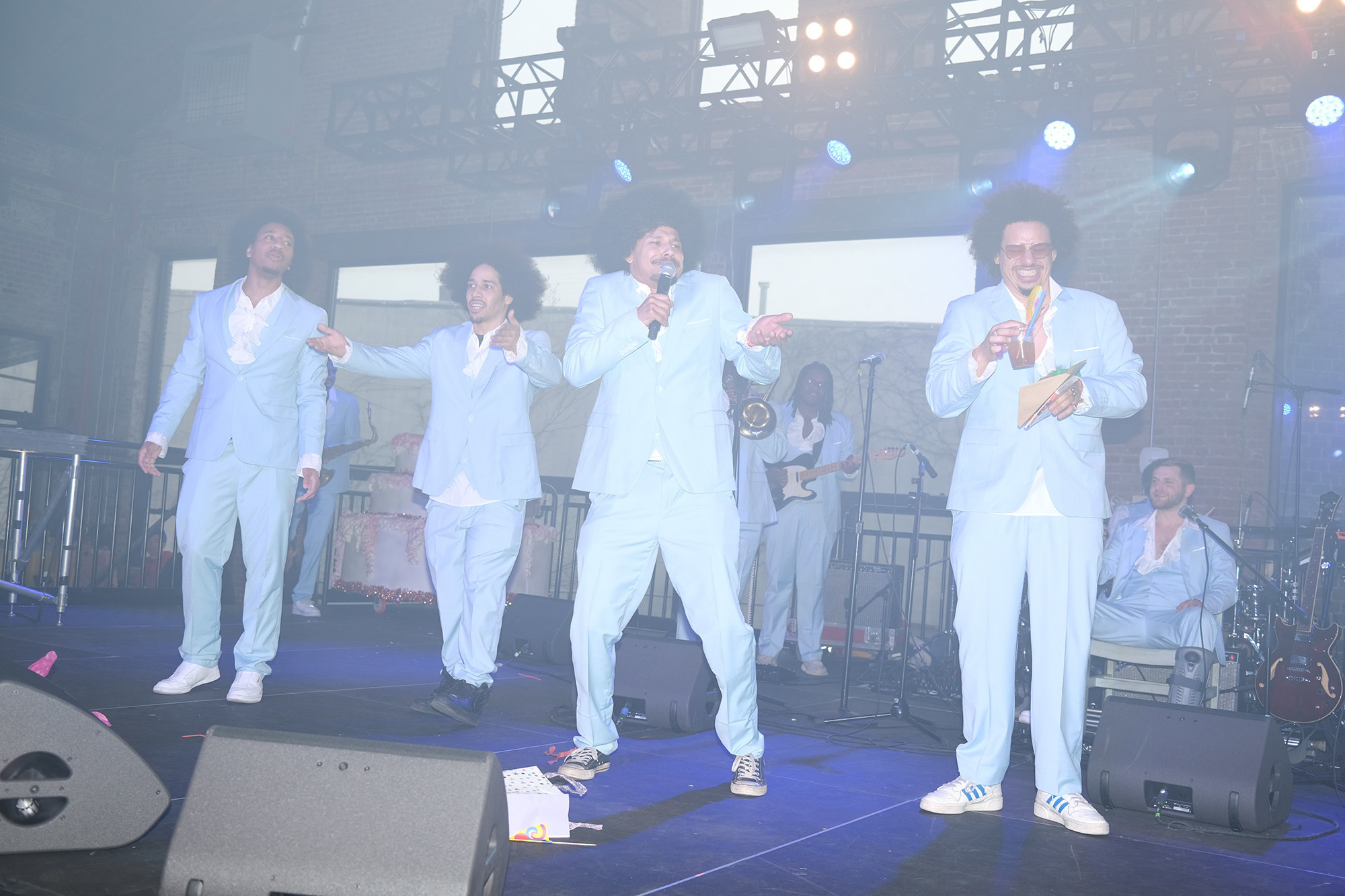 Eric André and several lookalikes stand together on stage