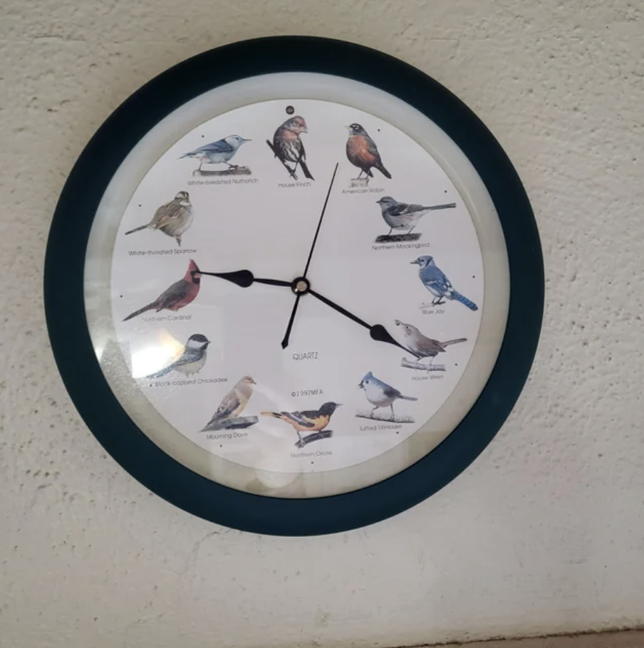 An old clock with birds on it