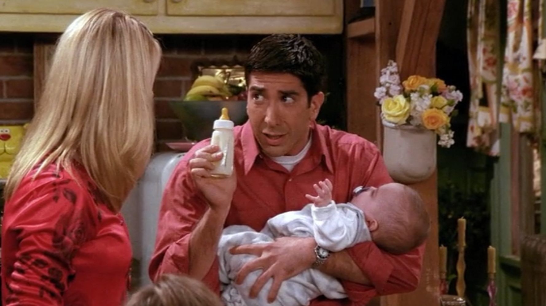 Ross from &quot;Friends&quot; holding a baby and bottle.