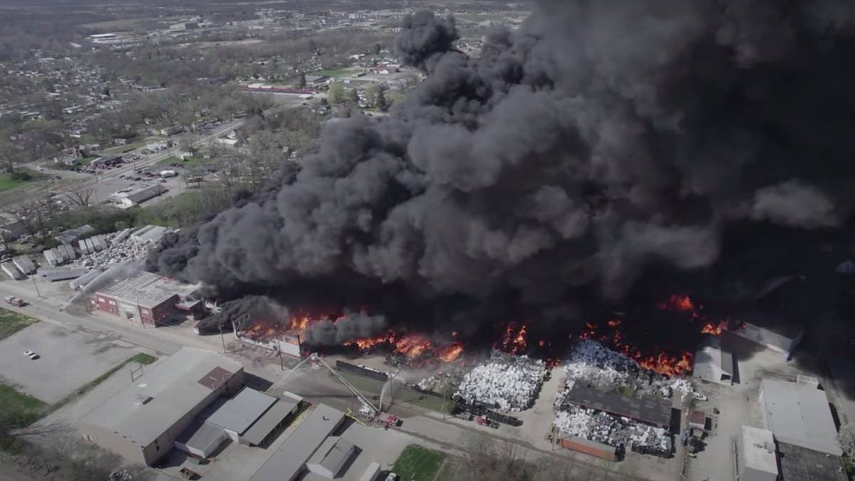 The large industrial fire broke out at a warehouse being used for recycling-related storage, officials said. Residents were urged to evacuate.