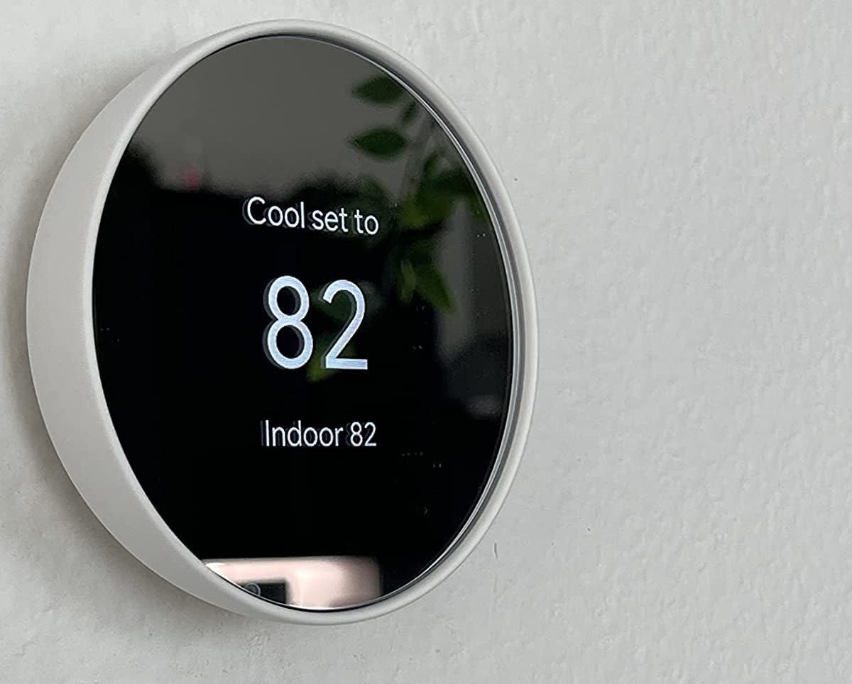 a reviewer photo of the thermostat on a wall