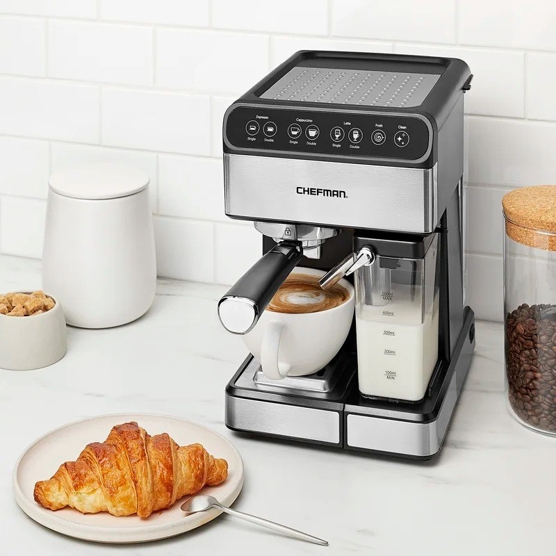 silver and black Chefman espresso machine next to plate with croissant
