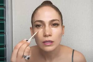 Jennifer Lopez applying makeup