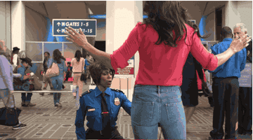 A TSA agent checking someone