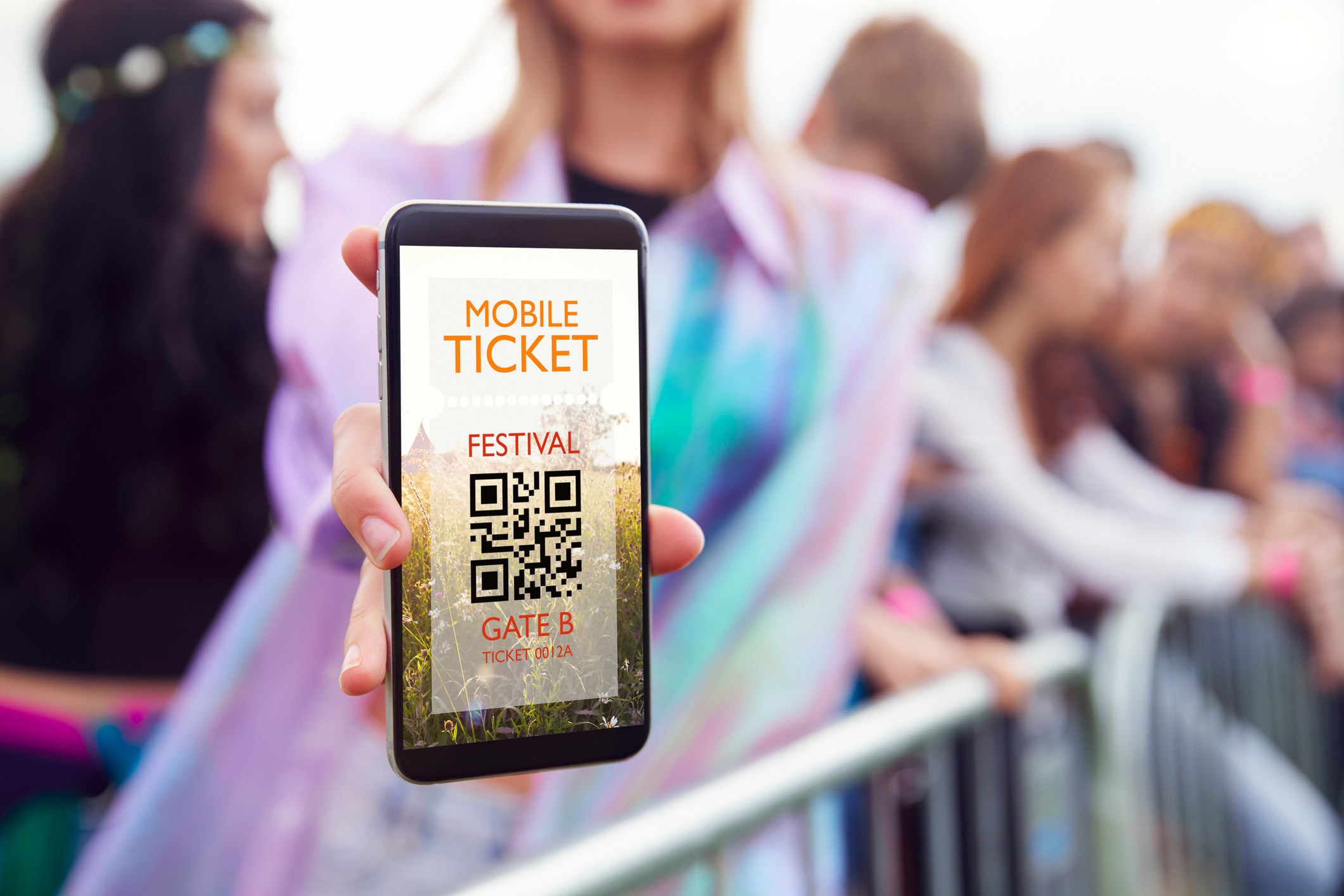 Someone showing a mobile ticket to a festival on their phone