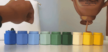 a gif of someone putting beauty items in the blue green and yellow containers