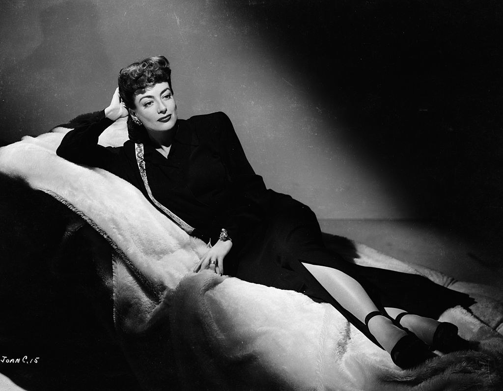 A woman laying on a chaise lounge