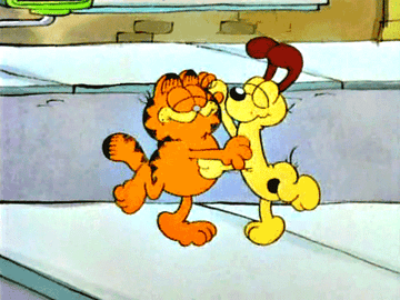 Garfield the cat and a dog dancing in the street together and smiling