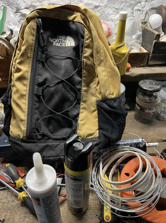 A North Face backpack surrounded by tools