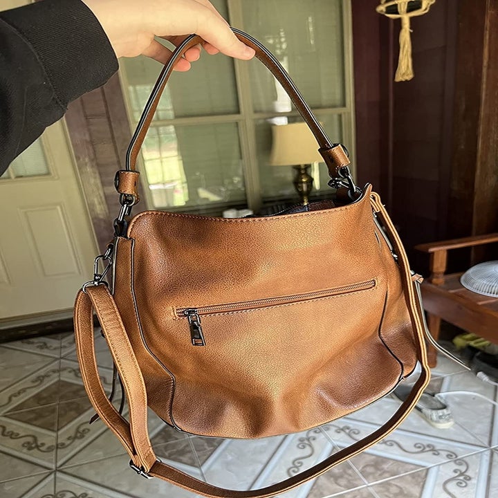 Reviewer holding the light brown bag