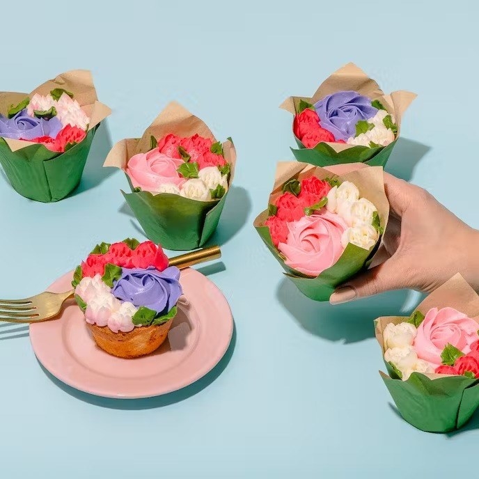 cupcakes with flowers piped on top of them